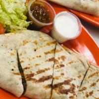 Steak Quesadilla · Our famous shawarma and a delicious blend of mixed cheese topped with lettuce, tomato, onion...