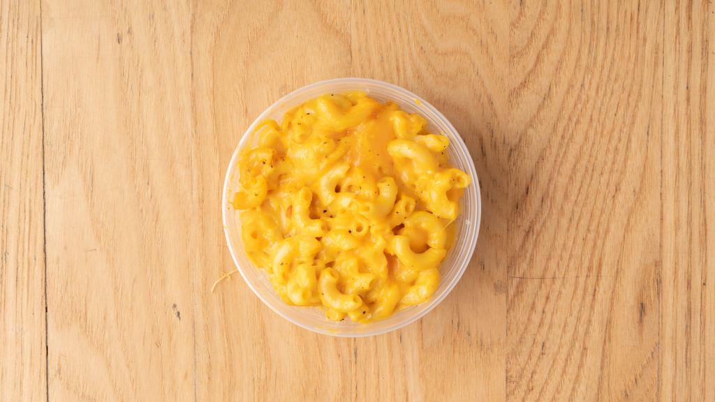Magnificent Macaroni And Cheese · Elbow macaroni covered in a creamy three cheese sauce and baked to a golden brown