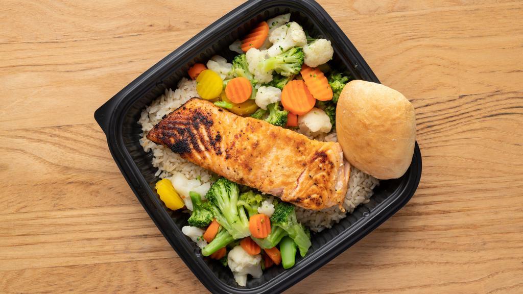 Salmon Dinner · Savory Salmon filet served along side white rice, fresh steamed vegetable's of the day and a dinner roll