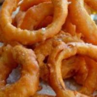 Batter Dipped Onion Rings · Beer battered onion rings fried to a golden brown served with ranch dressing.