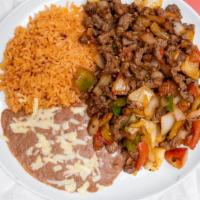 Bistec Mexicano · Charbroiled steak with sautéed jalapeños, onion, and tomatoes. Served with rice, refried bea...