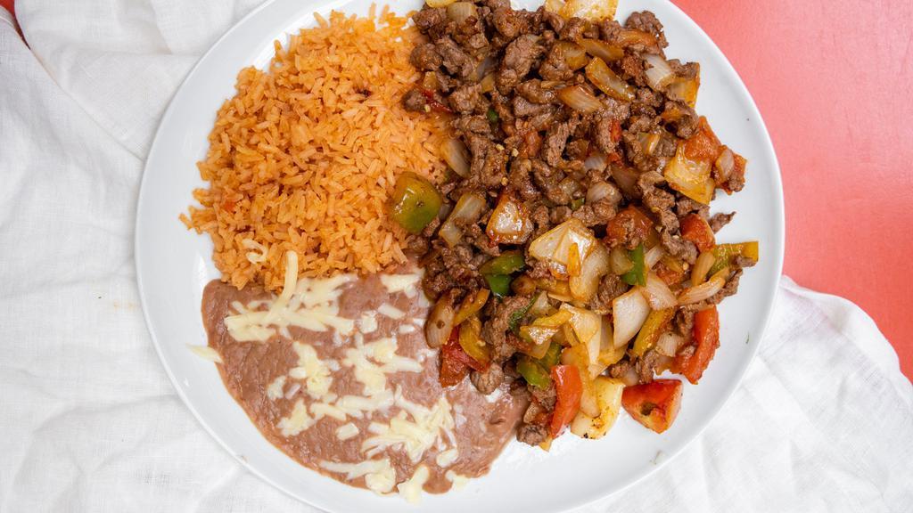 Bistec Mexicano · Charbroiled steak with sautéed jalapeños, onion, and tomatoes. Served with rice, refried beans, and your choice of corn or flour tortillas. Beverage is included.