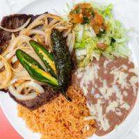 Carne Asada · Authentic carne asada (steak) and fried onions. Served with rice, refried beans, salad, tort...