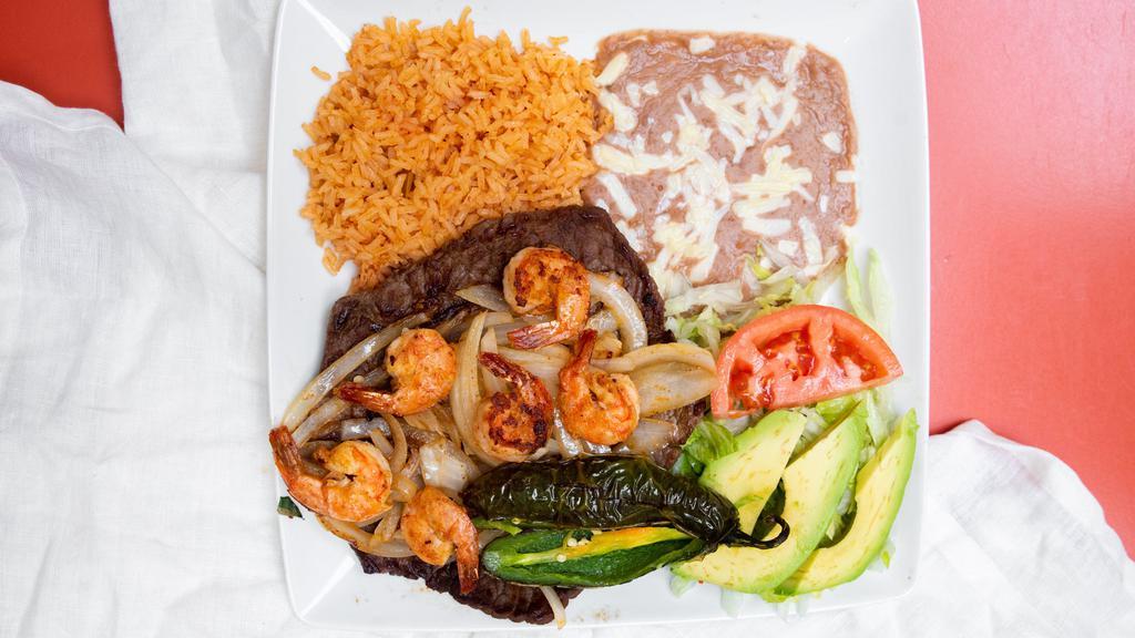 Mar Y Tierra · Authentic carne asada and shrimp. Served with rice, refried beans, a salad with fresh avocado, tortillas (corn or flour), and a fried jalapeño. Beverage included.