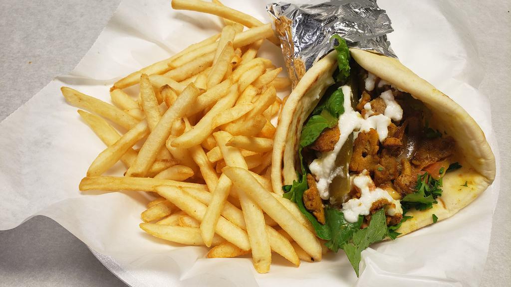 Chicken Shawarma Sandwich · Marinated white chicken strips with lettuce, tomatoes, onions and pickles with garlic sauce, wrapped in a hot pita bread.