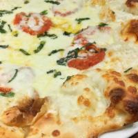 Pizza Primavera · Vine ripened tomatoes, thick cut fresh mozzarella, and torn basil finished with olive oil.