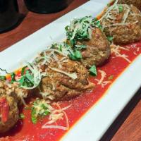 Meatballs · Beef and pork meatballs served in a pool of pomodoro sauce and garnished with fresh basil an...