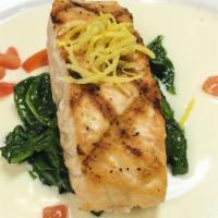 Salmon And Spinach · Grilled salmon fillet over garlic wilted spinach with lemon butter and topped with tomato re...