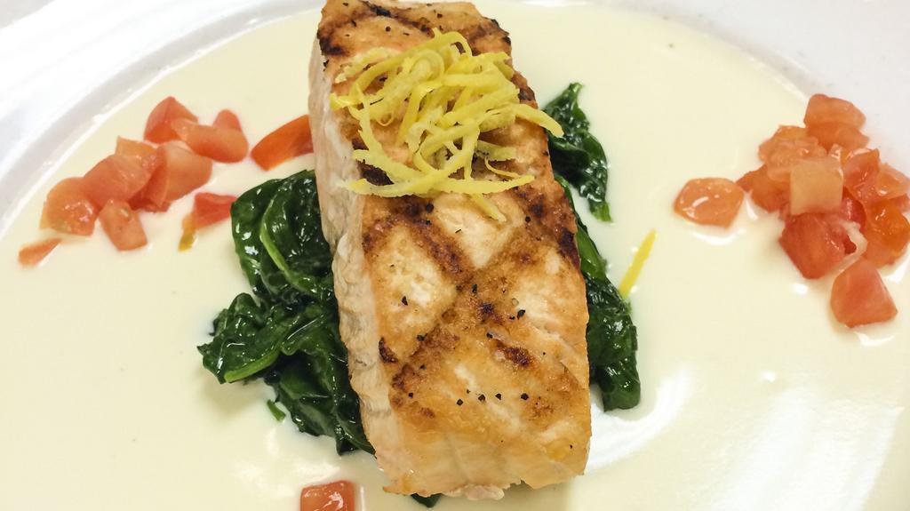 Salmon And Spinach · Grilled salmon fillet over garlic wilted spinach with lemon butter and topped with tomato relish
