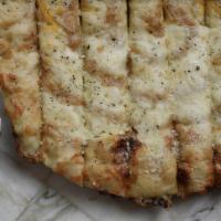 Cheesy Garlic Bread · Homemade roasted garlic purée and melty mozzarella cheese topped with parmesan, Italian herb...