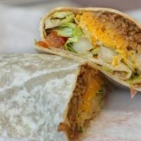 Taco Burrito · Wrapped in a flour tortilla, a mixture of seasoned ground beef and refried beans, lettuce, c...