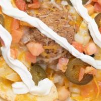 Nachos Deluxe · On a plate of fresh tortilla chips we melt cheese, and add refried beans, jalapeño peppers, ...