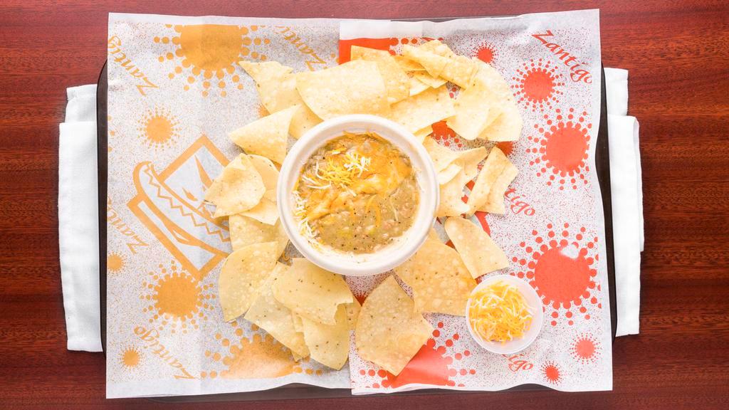 Bowl Of Green Chili · A bowl of our famous green chili and cheese, with a side of fresh fried tortilla chips.