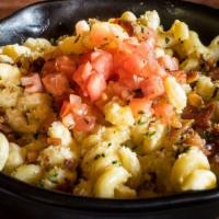 Loaded Mac-N-Cheese · Made from scratch cheese sauce tossed in cavatappi noodles then baked with bread crumb crust...