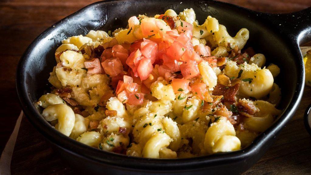 Loaded Mac-N-Cheese · Made from scratch cheese sauce tossed in cavatappi noodles then baked with bread crumb crust, diced tomatoes, shredded parmesan cheese and chopped Applewood smoked bacon.  Served with a grilled parmesan ciabatta toast point.