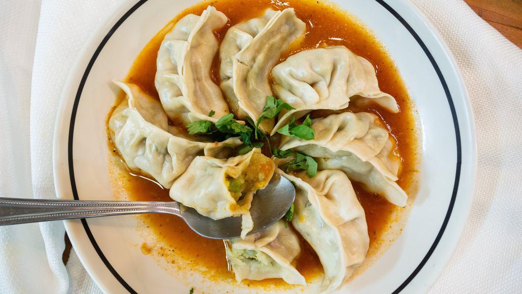 Alu Momo (8) · Eight pieces of made from scratch momos steamed dumpling stuffed with seasoned potatoes served with our special homemade momo sauce.
