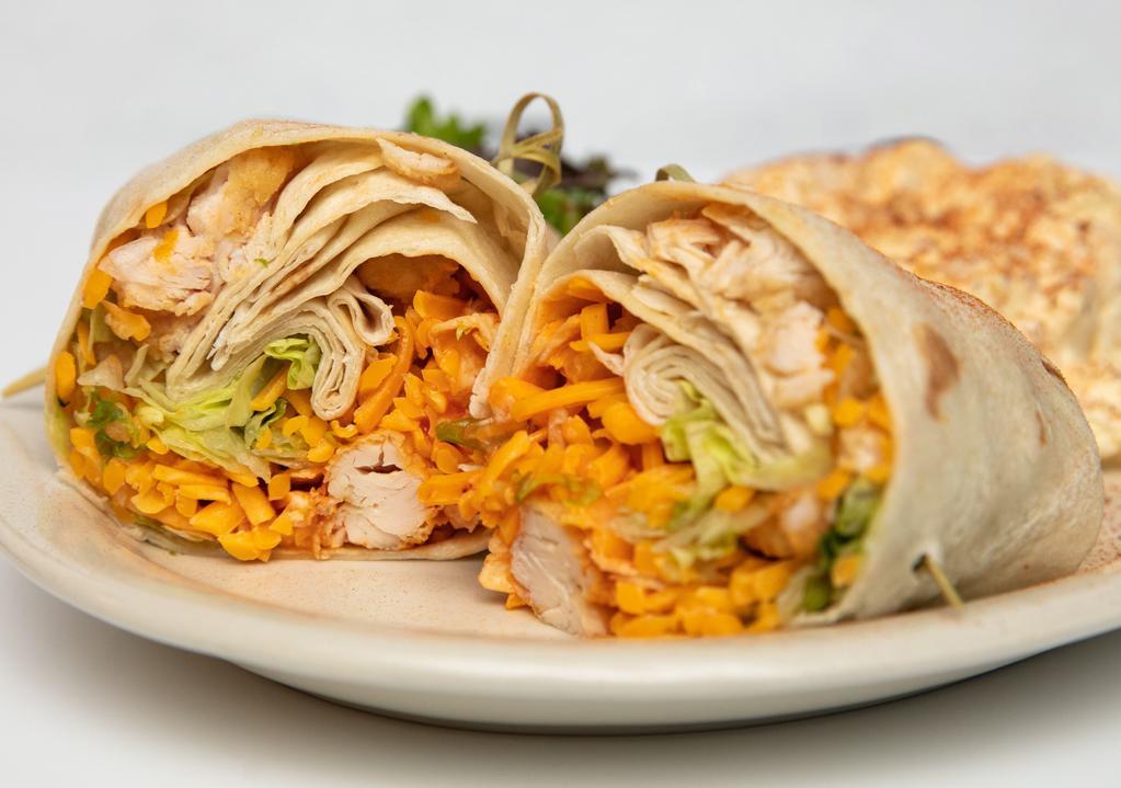 Buffalo Chicken Wrap · Hand breaded chicken tenders, cheddar cheese, and romaine lettuce tossed with our house buffalo sauce and wrapped in a fresh tortilla. Served with Parmesan peppercorn ranch or blue cheese dressing.