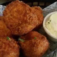 Potato Poppers · Deep fried garlic mashed potato balls mixed with cheddar cheese, bacon, and jalapenos served...