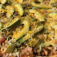 Taco Pizza · pizza sauce, ground beef and jalapeños topped with lettuce, tomato, onion, avocado, and ched...