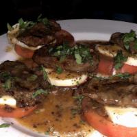 Steak Caprese Salad · Premium grade seasoned steak served over fresh tomato and topped with fresh mozzarella and d...