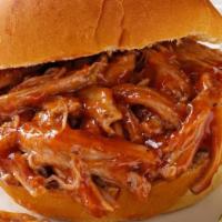Pulled Pork Sandwich · tender hand pulled pork in Tennessee spices tossed in apple bourbon BBQ sauce topped with ch...