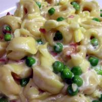 Tortellini Alla Panna · tortellini in alfredo sauce with ham, peas, & mushrooms

includes house salad - substitute s...