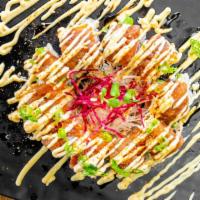 Tuna Delight · Tuna and avocado topped with salmon and spicy tuna. Spicy mayo, eel sauce, scallions, sesame...