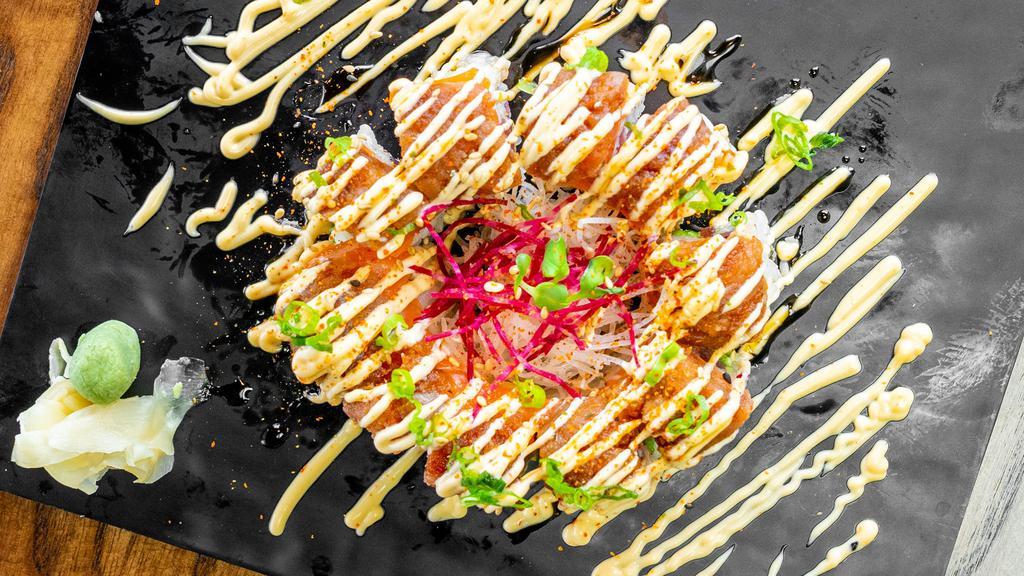 Tuna Delight · Tuna and avocado topped with salmon and spicy tuna. Spicy mayo, eel sauce, scallions, sesame seeds