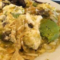 Chilaquiles · Tortilla chips tossed with melted mozzarella cheese, eggs and green salsa verde, topped with...