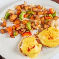 Eggs Benedict · Two poached eggs over Canadian bacon on an English muffin with hollandaise sauce