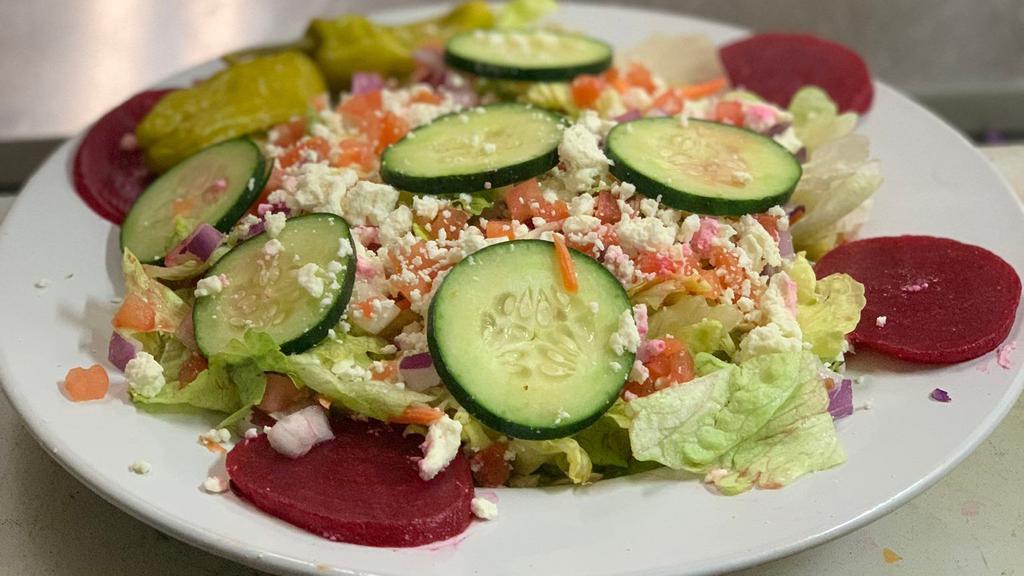 Greek Salad · ROMAINE,,  cucumbers, onions, tomatoes, beets, pepperoncini's and feta with Greek dressing.