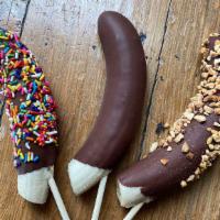 Frozen Bananas · Banana on a stick dipped in home-made chocolate shell.