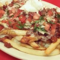 Papas Locas · French fries topped with mexican sausage, pico de gallo, cheese dip and sour cream.