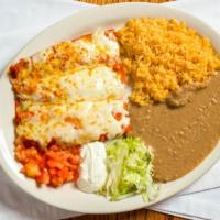Enchiladas Dinner · Three fried corn tortillas dipped in red or green enchilada sauce, filled with your choice o...