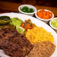 Arrachera · Tender skirt steak served with rice, beans, guacamole, pico de gallo, grilled onions, serran...