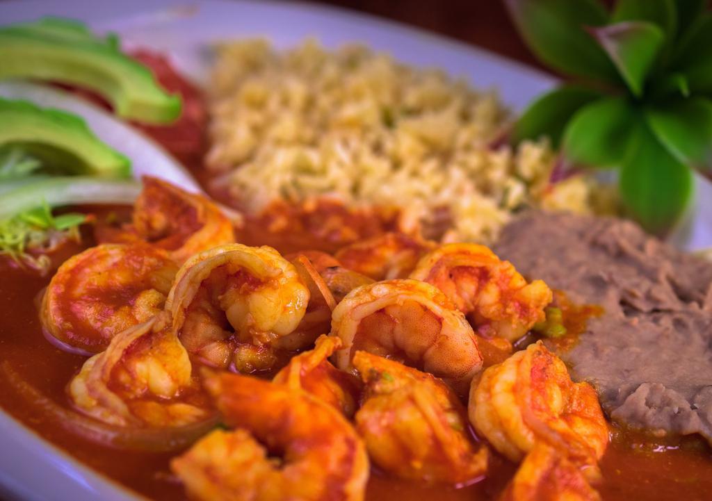 Camarones A La Diabla · Sauteed shrimp cooked with onion and green pepper in a spicy traditional red sauce, served with rice, beans, Lettuce, tomato and guacamole.