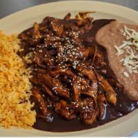 Pollo En Mole Poblano · Shredded chicken breast simmered in our very own Mole Poblano made from scratch. Served with...