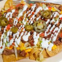 Loaded Nachos · Fresh chips covered in beans, melted cheese, your choice of meat, sour cream, lettuce, tomat...