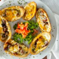 Potato Skins · Six loaded skins smothered with bacon and cheddar cheese, served with sour cream on the side.