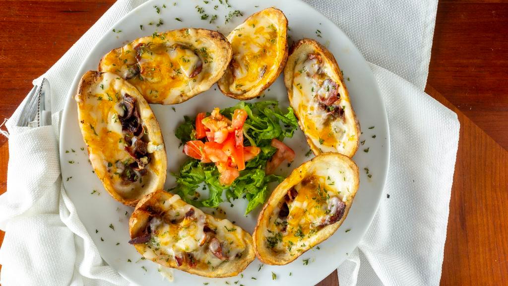 Potato Skins · Six loaded skins smothered with bacon and cheddar cheese, served with sour cream on the side.