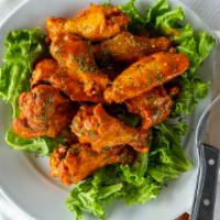 Albanian Wings · Ten crispy wings tossed in our house-made tangy albanian style sauce. We can also toss in sp...