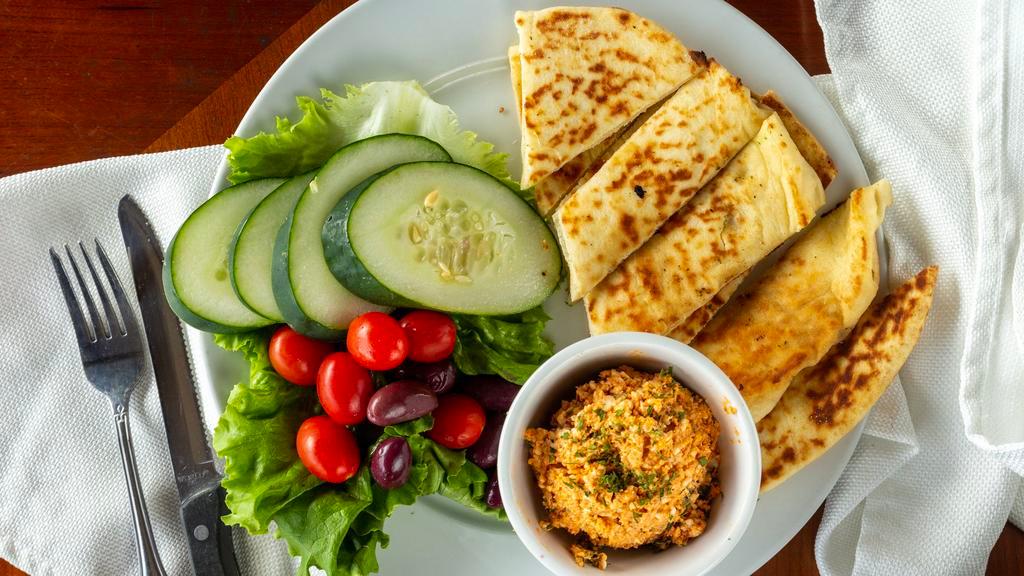 Fiesty Fiesta Dip · A creamy dip full of Mediterranean flavor with a touch of spice. Served with grilled flat bread and fresh veggies.