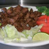Loc Lac · Marinated beef cooked quickly in a smoky wok served with lettuce, tomato, cilantro & a lime ...