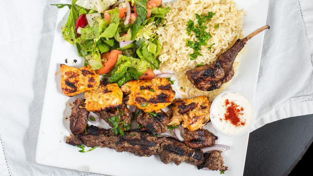 Mix Kebab Platter · Combination of grilled chicken, kofta, lamb, served over a bed of basmati rice.