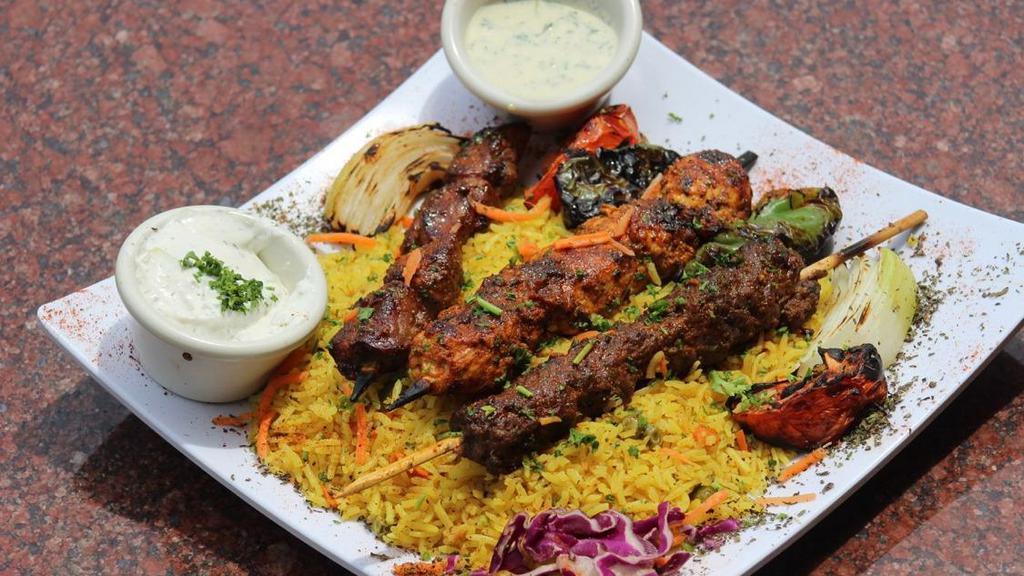 Kofta Kebab Platter · two  square of marinated  lamb and beef, mixed with parsley, onion,  , grilled veggie (onion, tomato,green pepper ) over a bed of basmati rice. comes with small salad.