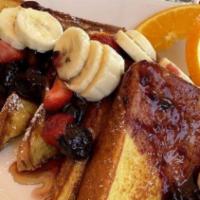 Triple Berry Swirl French Toast · 4 slices of the cinnamon swirl French toast topped with strawberry, banana and blueberry gla...