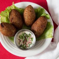 Kibbeh (4 Pieces) · 4 patty of cracked wheat mixed with lamb meat on the outer shell, stuffed with ground lamb, ...