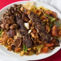 Big Mashawi Mix Plate With Hummus · Two skewers each of grilled fresh lamb cubes, white chicken meat cubes, shish kabobs, pieces...