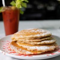 Cinnamon Swirl Pancakes · Four pancakes with icing.