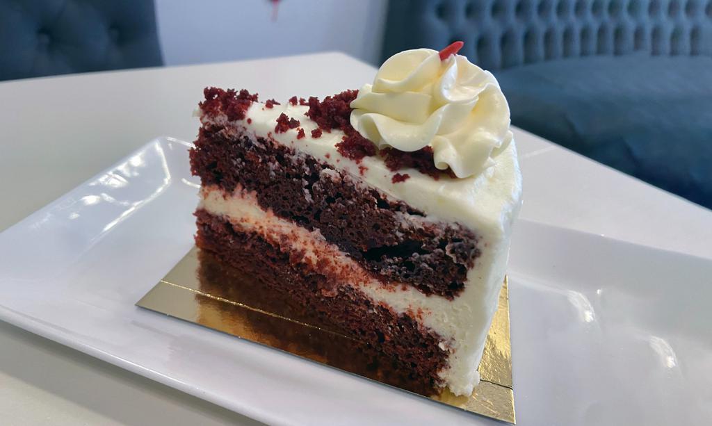 Red Velvet (Slice) · A large slice of our 8in layered red velvet cake with cream cheese filling and icing.